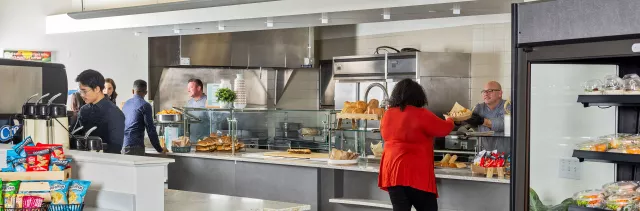 Wide shot of cafeteria with customers and chefs